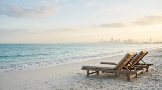 Plage isolée et luxueuse à Dubaï avec transats vides face à une mer turquoise calme, loin de la foule
